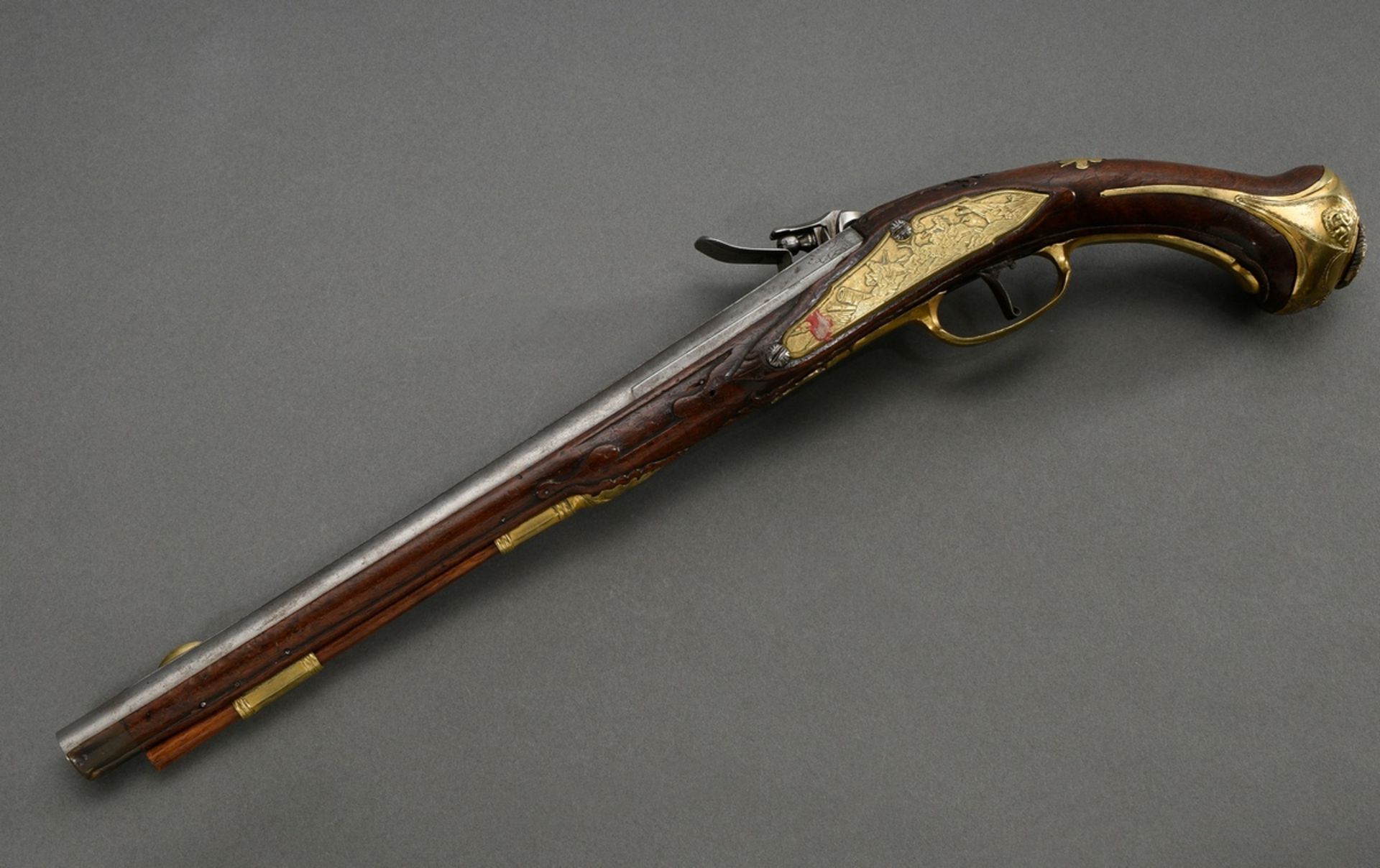 Muzzle loading flintlock cavalry pistol with iron barrel and brass gilt, finely engraved fittings "