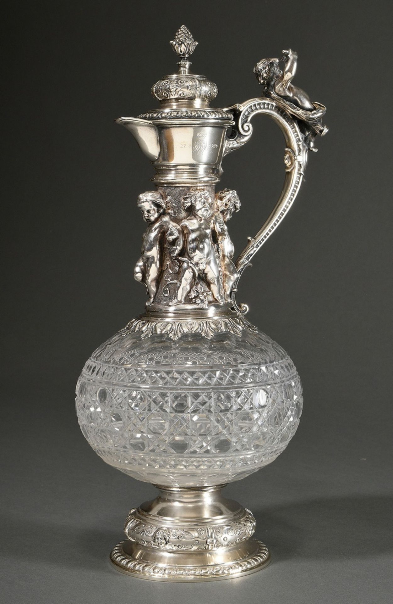 An imposing Baccarat-cut crystal tankard with opulent figural silver mounting ‘Putti as Bacchantes’