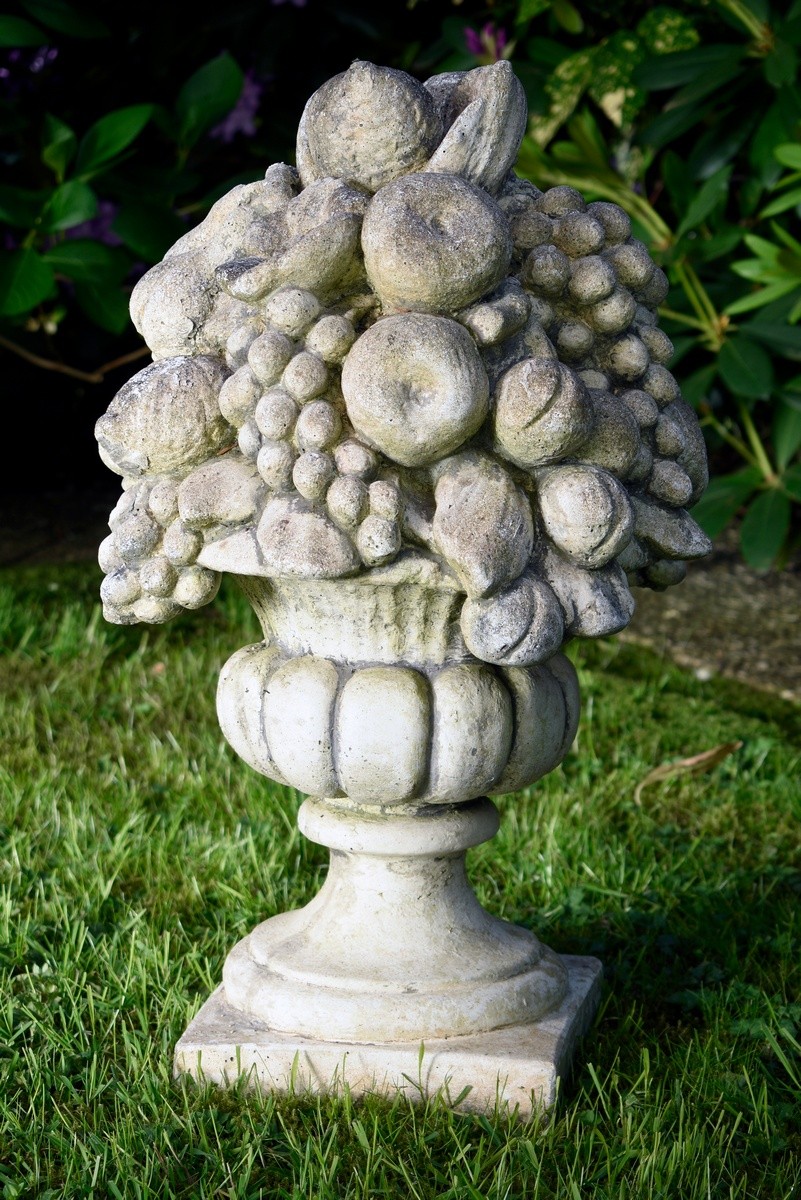 Decorative cast stone garden vase with sculptural fruit bouquet on a square pedestal, 20th century,