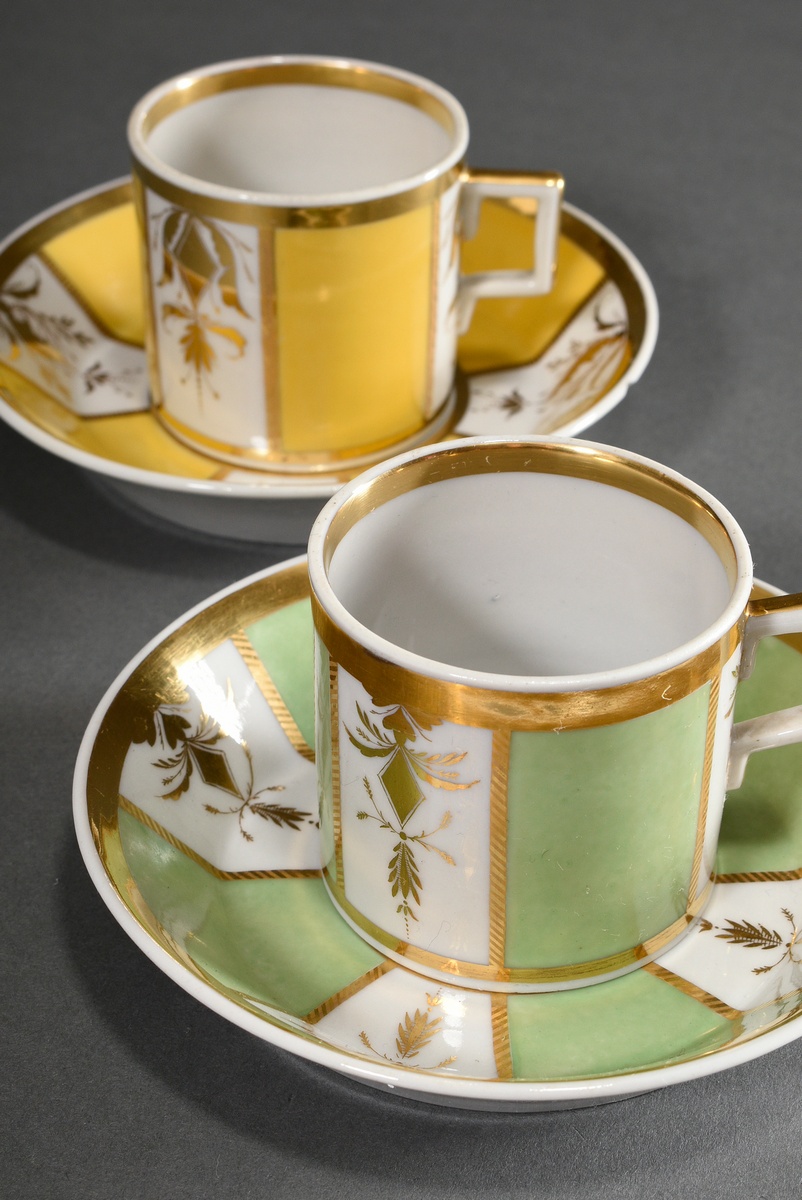 2 Cylindrical Empire cups/saucers with alternating gold tendrils and color fields in light yellow a