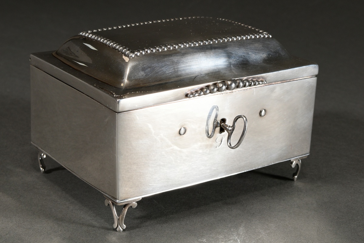 A plain Berlin sugar box on volute feet with pearl frieze and handle strip on the lid, Marked: Corn