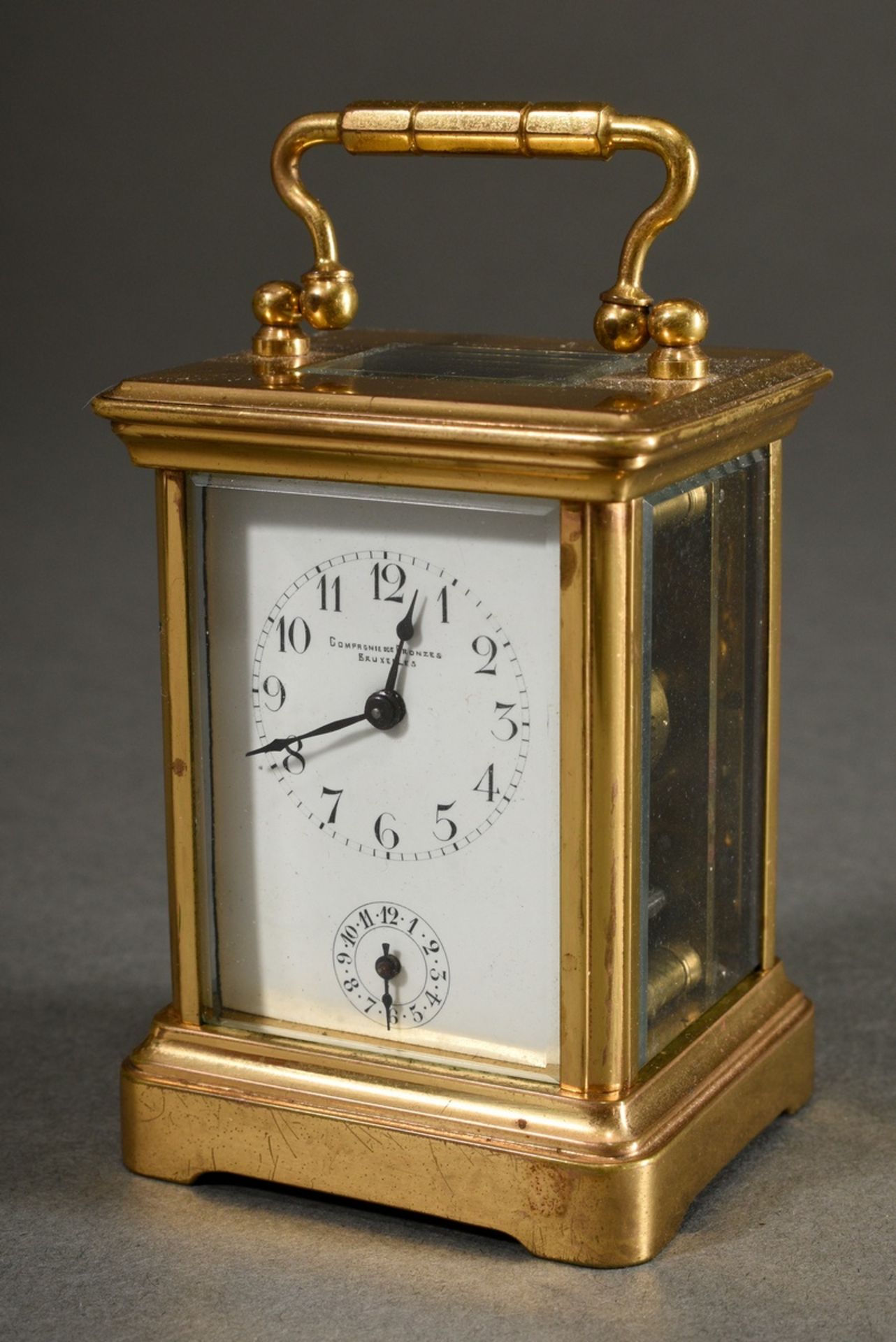 French miniature travel alarm clock in all-round glassed brass case, enamelled dial with Arabic num