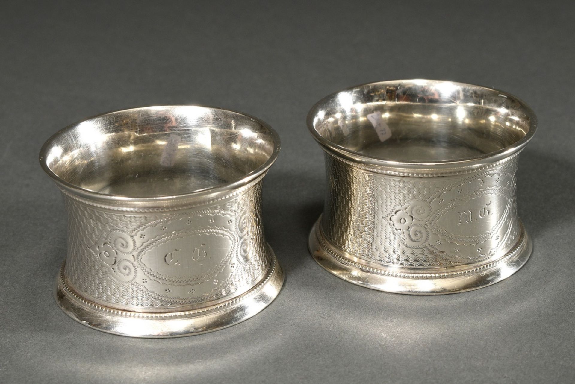 2 Guilloché napkin rings with Fraktur script monograms ‘CG/MG’, German, late 19th century, silver 1