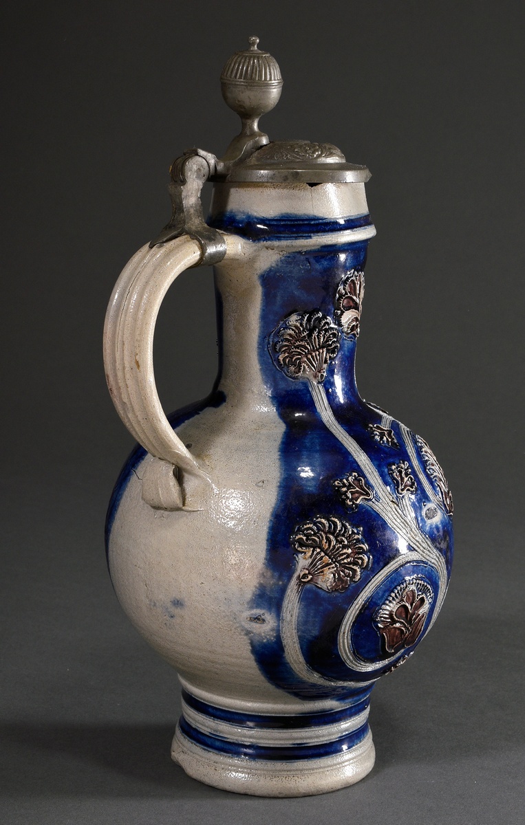 A baluster-shaped Westerwald tankard with semi-plastic floral ornaments and a wide strap handle cur - Image 3 of 8