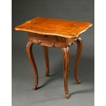 Small baroque side table with curved top and small drawer in the frame over curved legs, walnut and