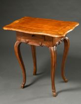 Small baroque side table with curved top and small drawer in the frame over curved legs, walnut and