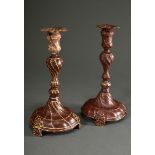 A pair of baroque pewter candlesticks with twisted features on a baluster shaft and bell foot over 