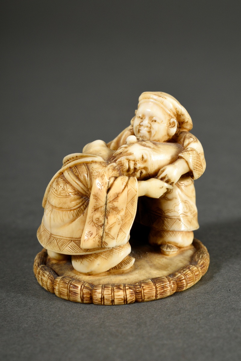 Fine ivory netsuke "The gods of fortune Daikoku and Fukurokuju in a sumo ring", signed in red lacqu
