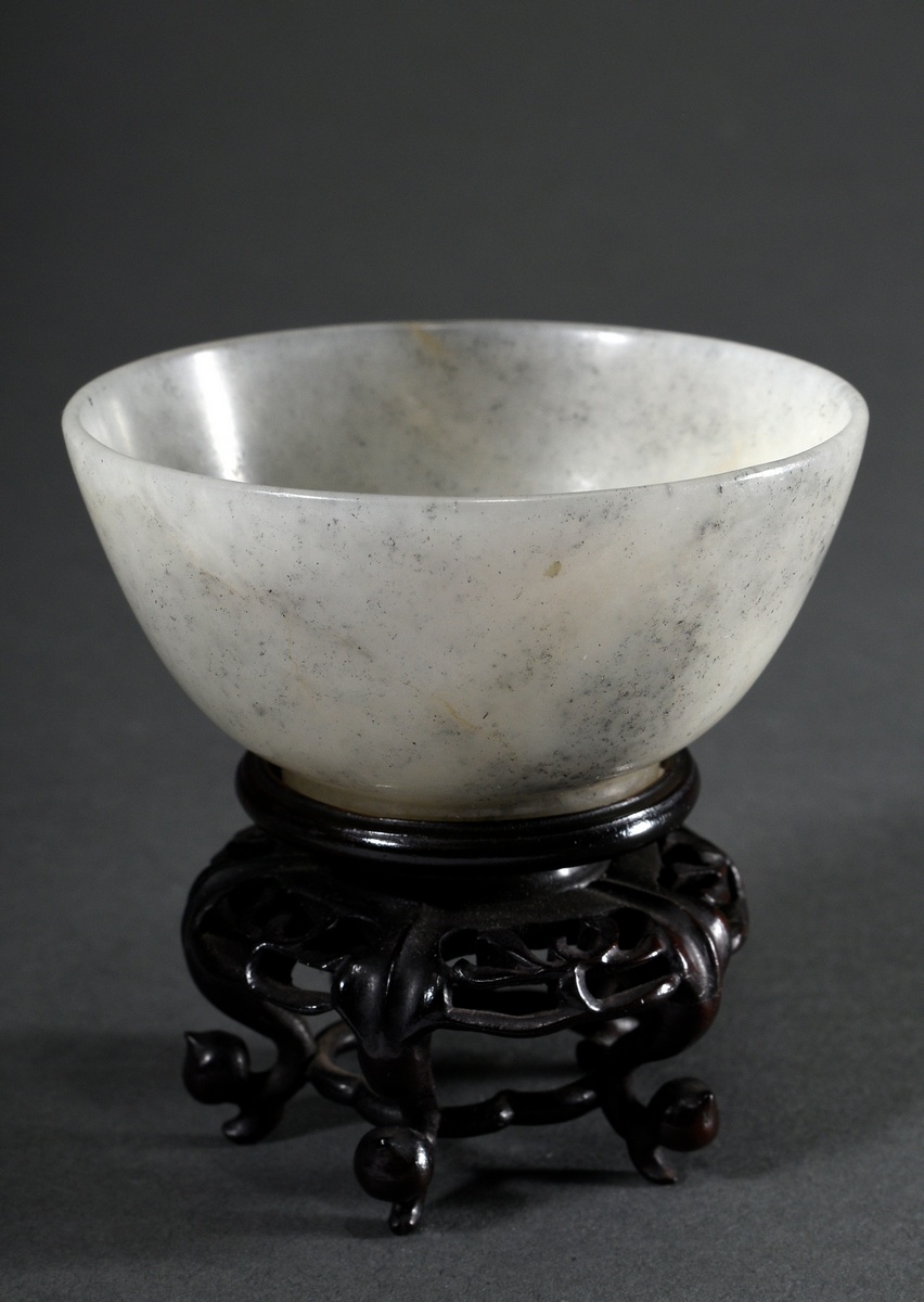 Light-coloured cloud jade bowl on a finely carved rosewood stand, Qing Dynasty, China, h. 3.3/6.6 Ø