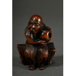 Boxwood netsuke "Fisherman on rock with ball (?)", movable contents, Himotoshi of different sizes, 