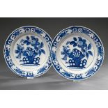 A pair of Dutch faience plates with floral blue painting decoration ‘Rock and Flowers’ after an Asi