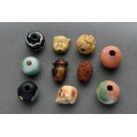 10 Various Ojime (緒締め) pearls made of different materials: 1 carved fruit core (signed), 1 bone "Sk