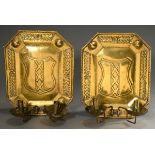 Pair of octagonal brass candlesticks with embossed decoration and coat of arms of Amsterdam and 2 i