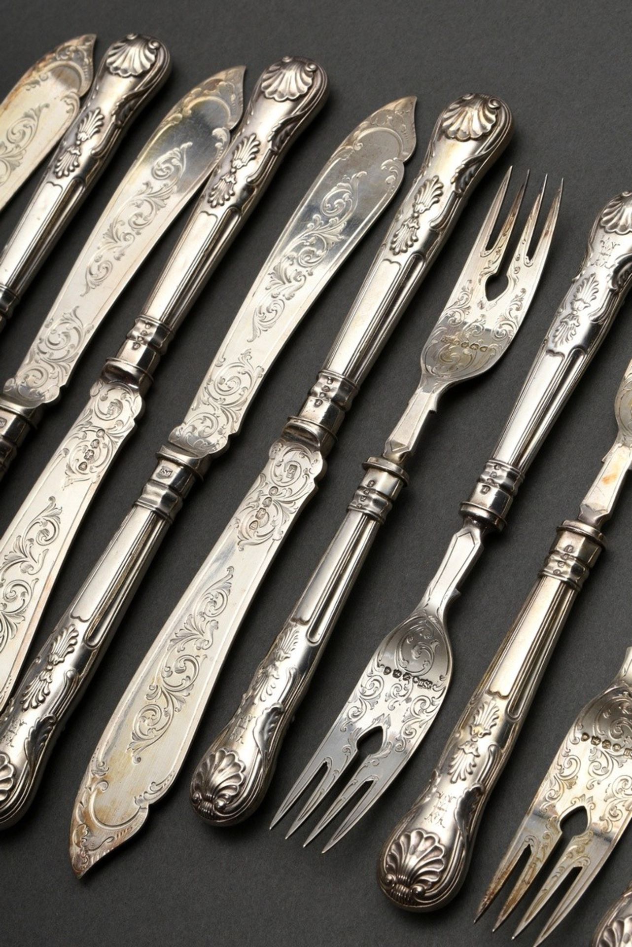 12 Pieces fish cutlery set with ornamentally engraved blades and spoons in the Kings pattern with m