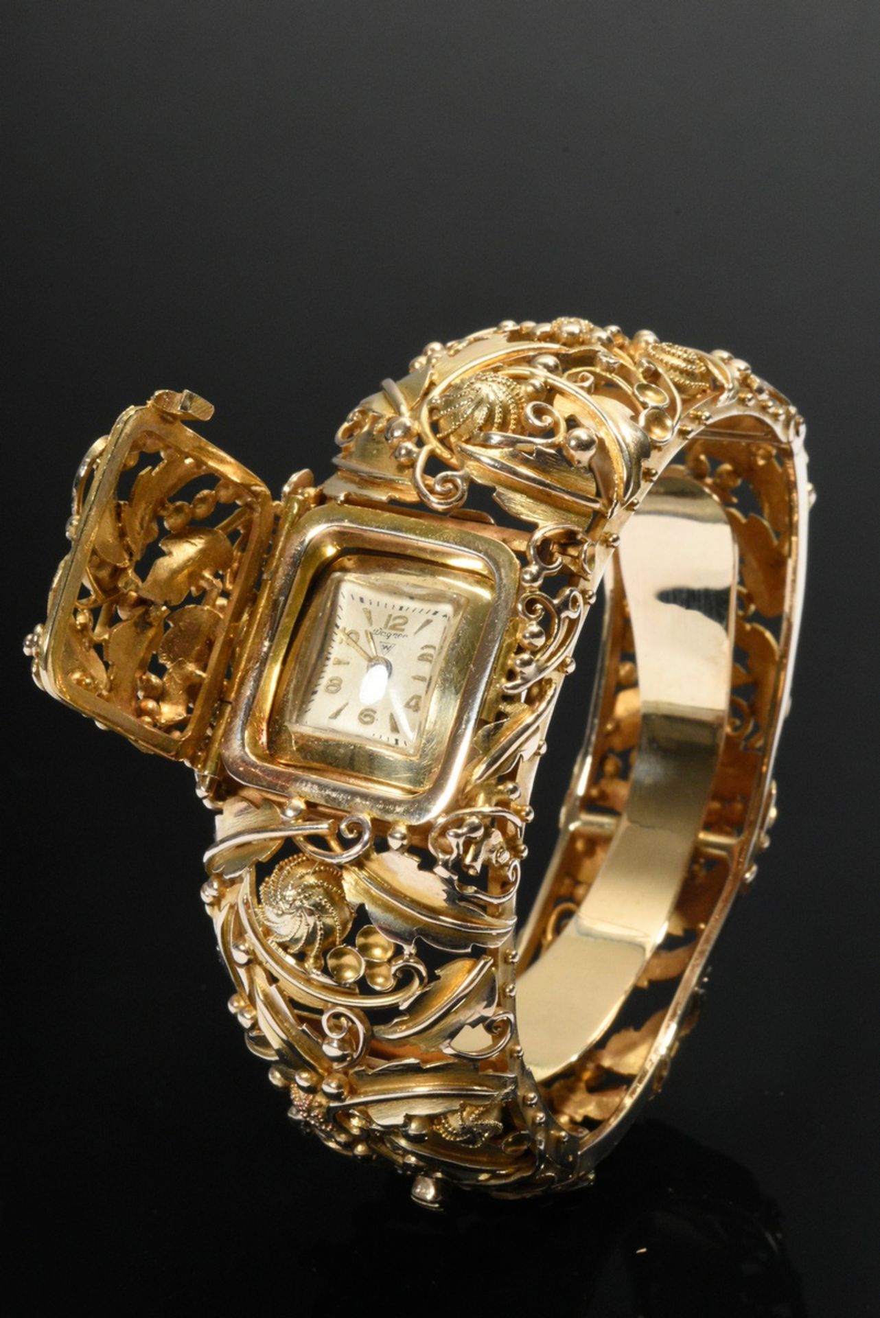 Oval yellow gold 585 bangle with hidden Wagner watch under hinged cover, leaf and flower ornaments  - Image 2 of 6