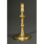 Yellow cast candlestick with high spout and baluster stem on a flower-shaped foot, England c. 1750/