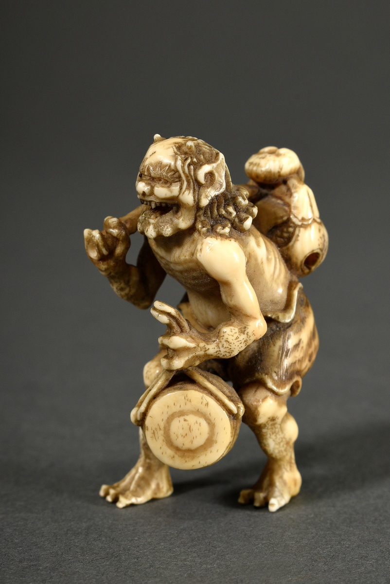 Very fine ivory netsuke "Oni with mokogyo slit drum, waniguchi gong and nyoi sceptre", sign. Tomoma