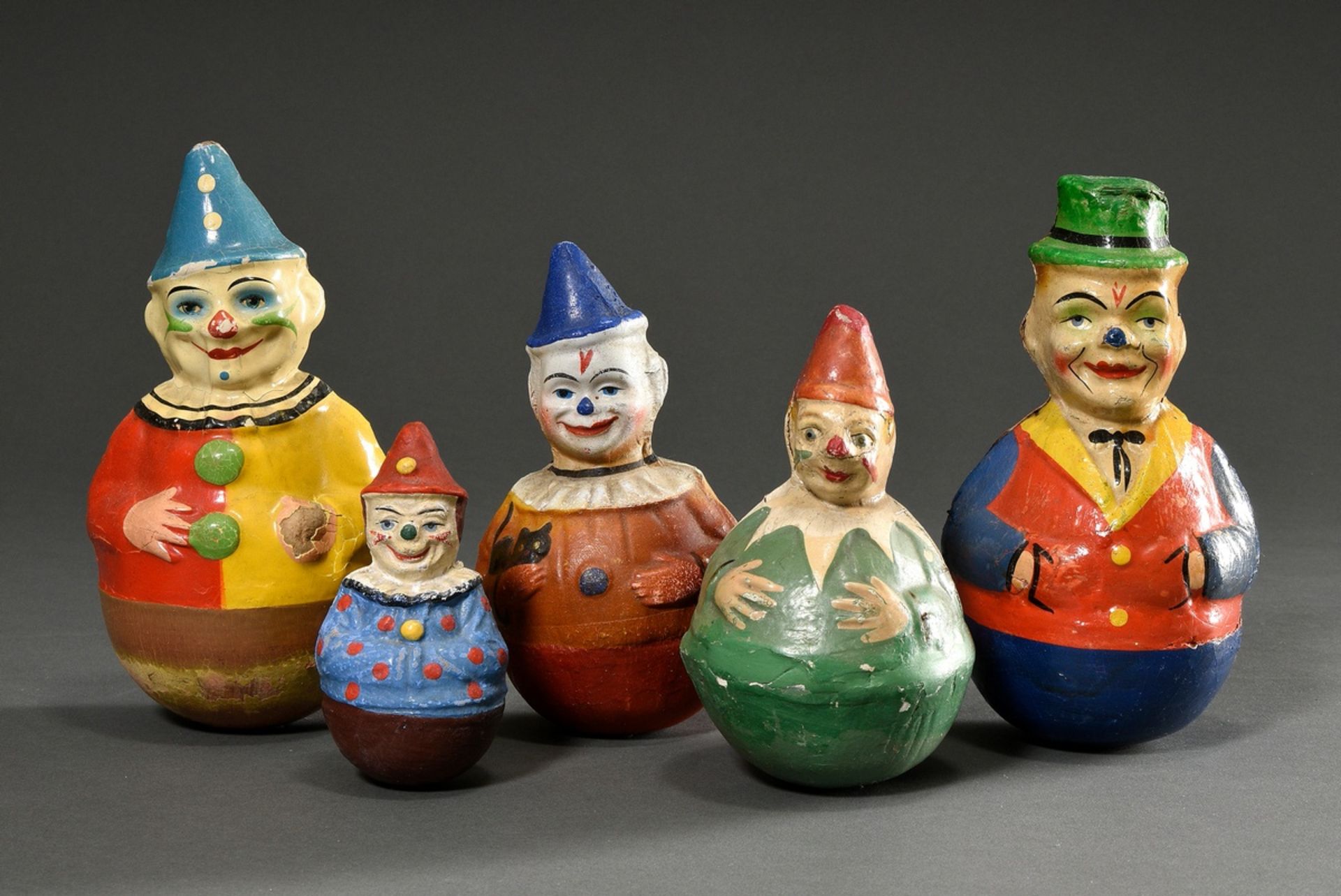 5 Various "Stand-up clowns", papier-mâché painted and sprayed in colour, h. 12-22cm, heavily used, 