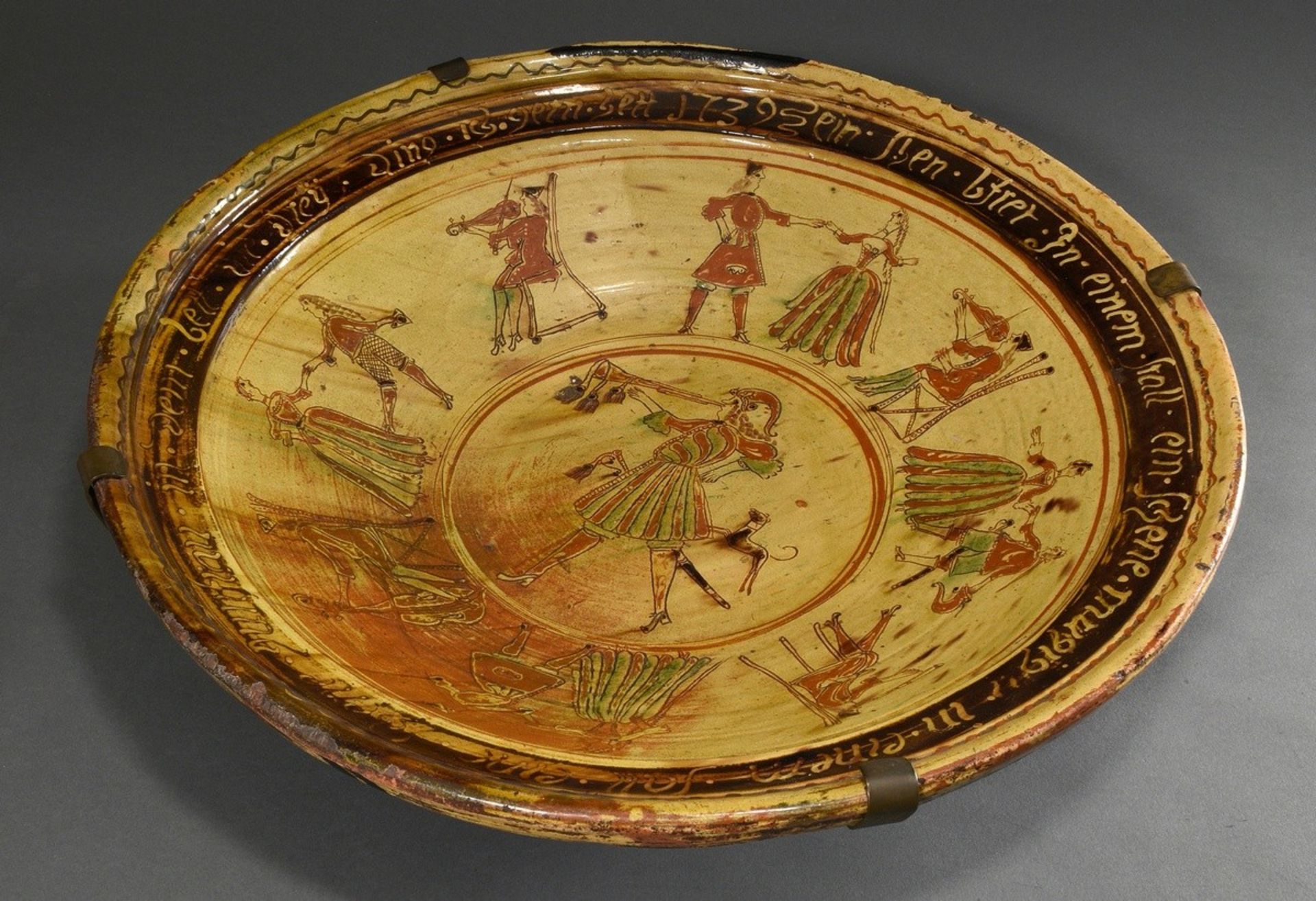 A very large Lower Rhenish potter's plate with incised decoration ‘Dancing couples and musicians’ a