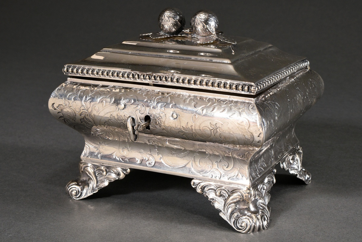 A Berlin sugar box of cambered form on foliate volute feet with embossed floral decoration, stepped