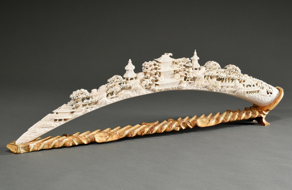 Richly carved ivory tooth "Landscape with pagodas, trees and people" on a carved and patinated wood