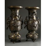 A pair of large bronze vases with sculpted dragon handles and relief cartouches depicting phoenixes