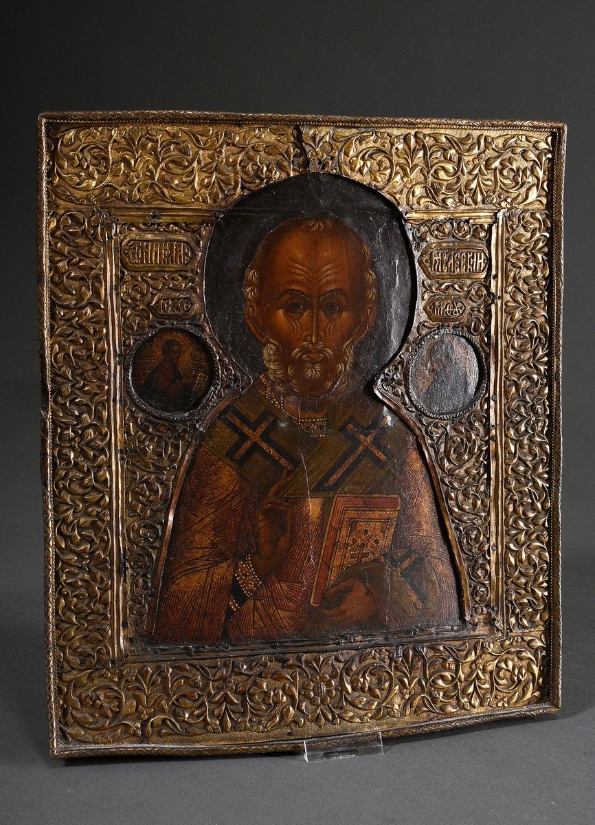 Russian icon "Saint Nicholas" under a florally embossed brass oklad, egg tempera/chalk ground on wo