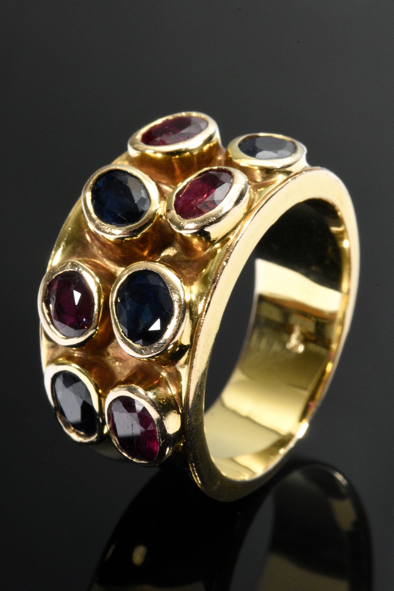 Wide yellow gold 585 ring irregularly set with rubies and sapphires, goldsmith's work, 11.6g, size 