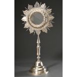 South American monstrance on a round base, reliquary with glass, scroll ornaments and aureole, silv