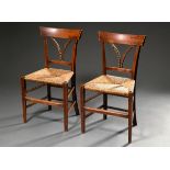 Pair of French farmhouse chairs with original wicker seats and carved ears of corn in the backrest,