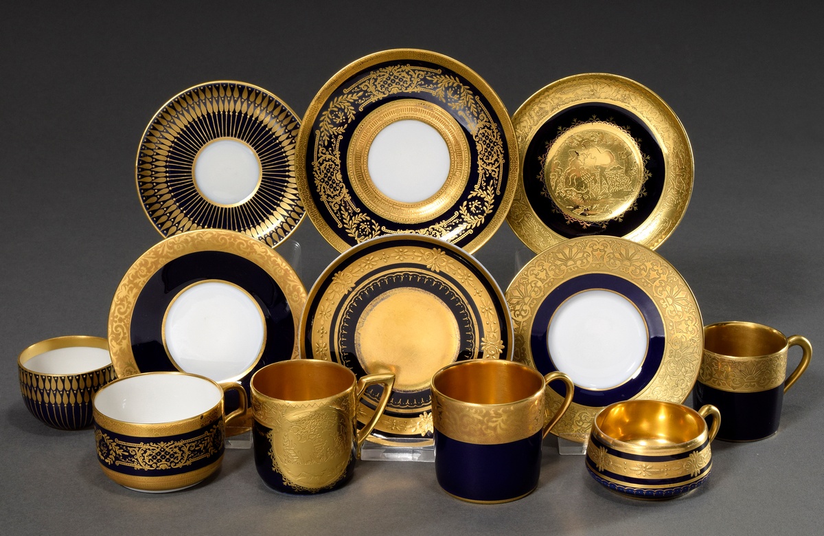6 Various moch cups/saucers with different ornamental relief gold decorations on a cobalt blue back