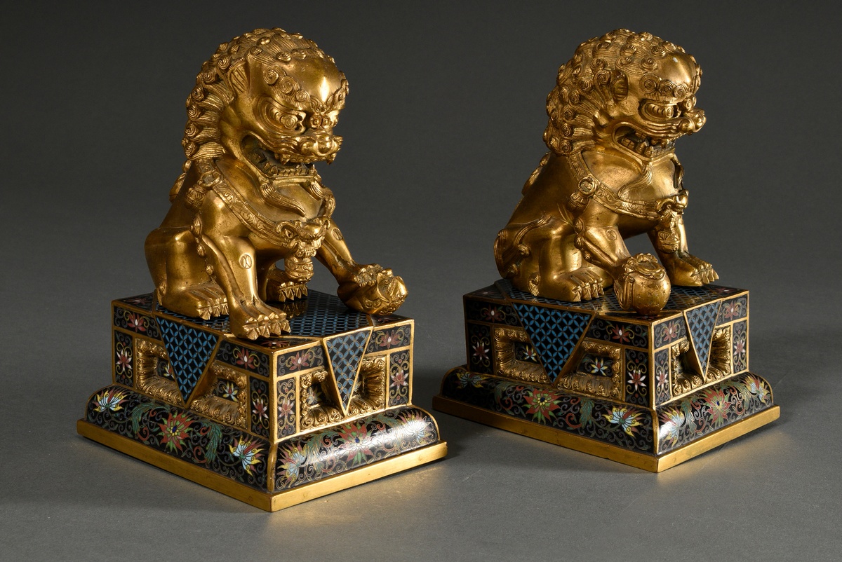 Pair of fire-gilt bronze Fo lions on angular cloisonné pedestals with polychrome borders and graphi - Image 2 of 9