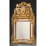 Small baroque mirror with carved "obelisk" top and floral decorations, wood gilded over bolus groun