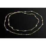 Long, delicate yellow gold 585 necklace with oval rainbow opal cabochons and small sapphire-set flo