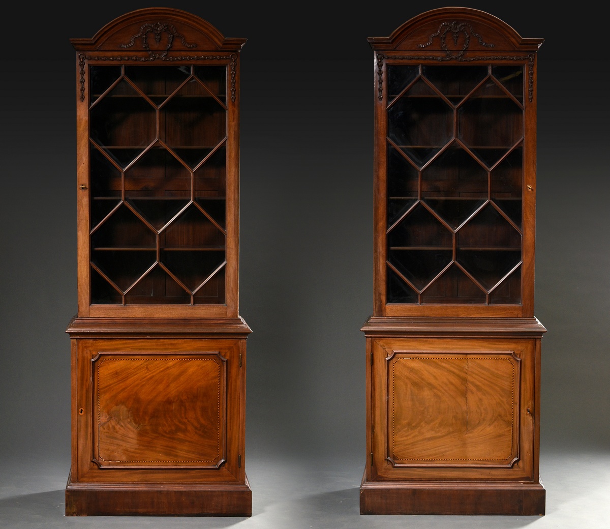 2 English bookcase library cabinets with round gables and floral carving reliefs in the Neoclassica