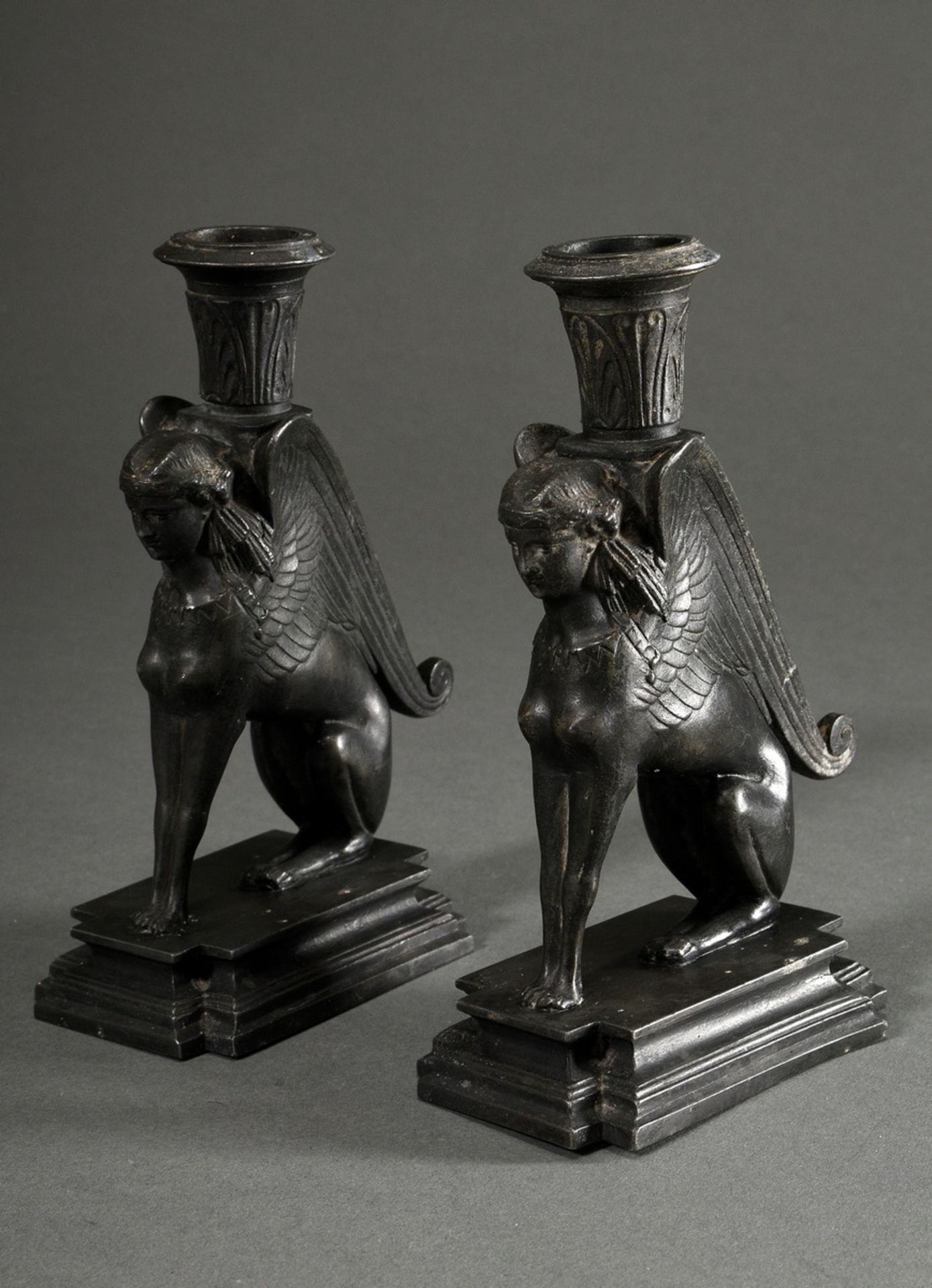 Pair of iron ‘Spinx’ candlesticks in classicist façon on angular pedestals, 2nd half 19th century, 