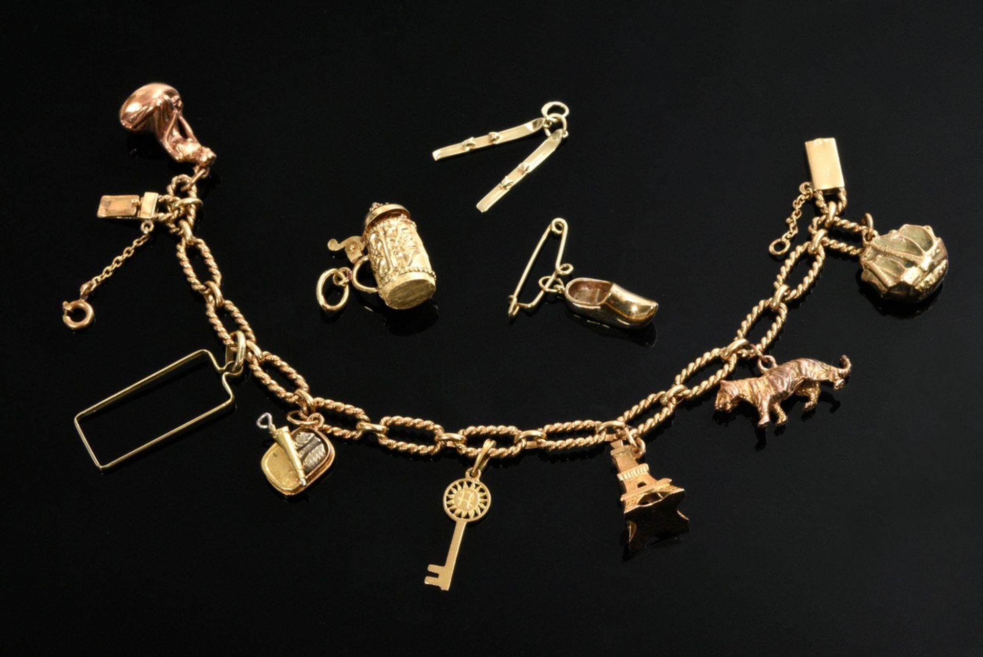 Classic yellow gold 800 charm bracelet with various pendants in different alloys: e.g. key, Eiffel 