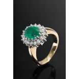 Classic white and yellow gold 585 ring with faceted emerald in a brilliant-cut diamond ring (togeth