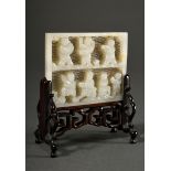Light-coloured jade plaque "7 playing children" in relief on open-worked latticework, wooden stand,