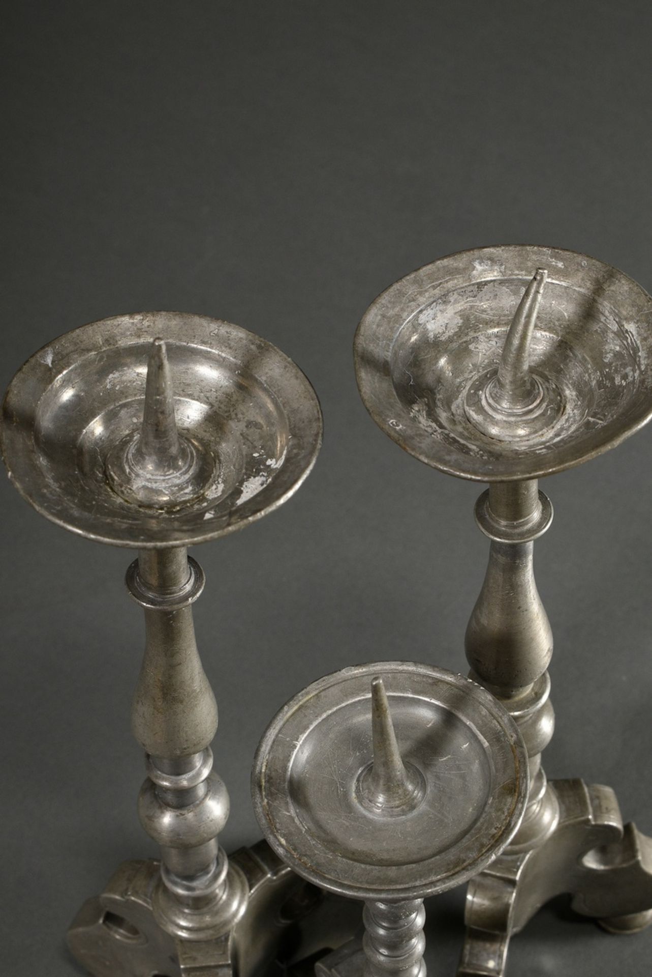 3 various baroque pewter candlesticks with baluster shaft over tripod and spike over protruding dri - Image 4 of 5