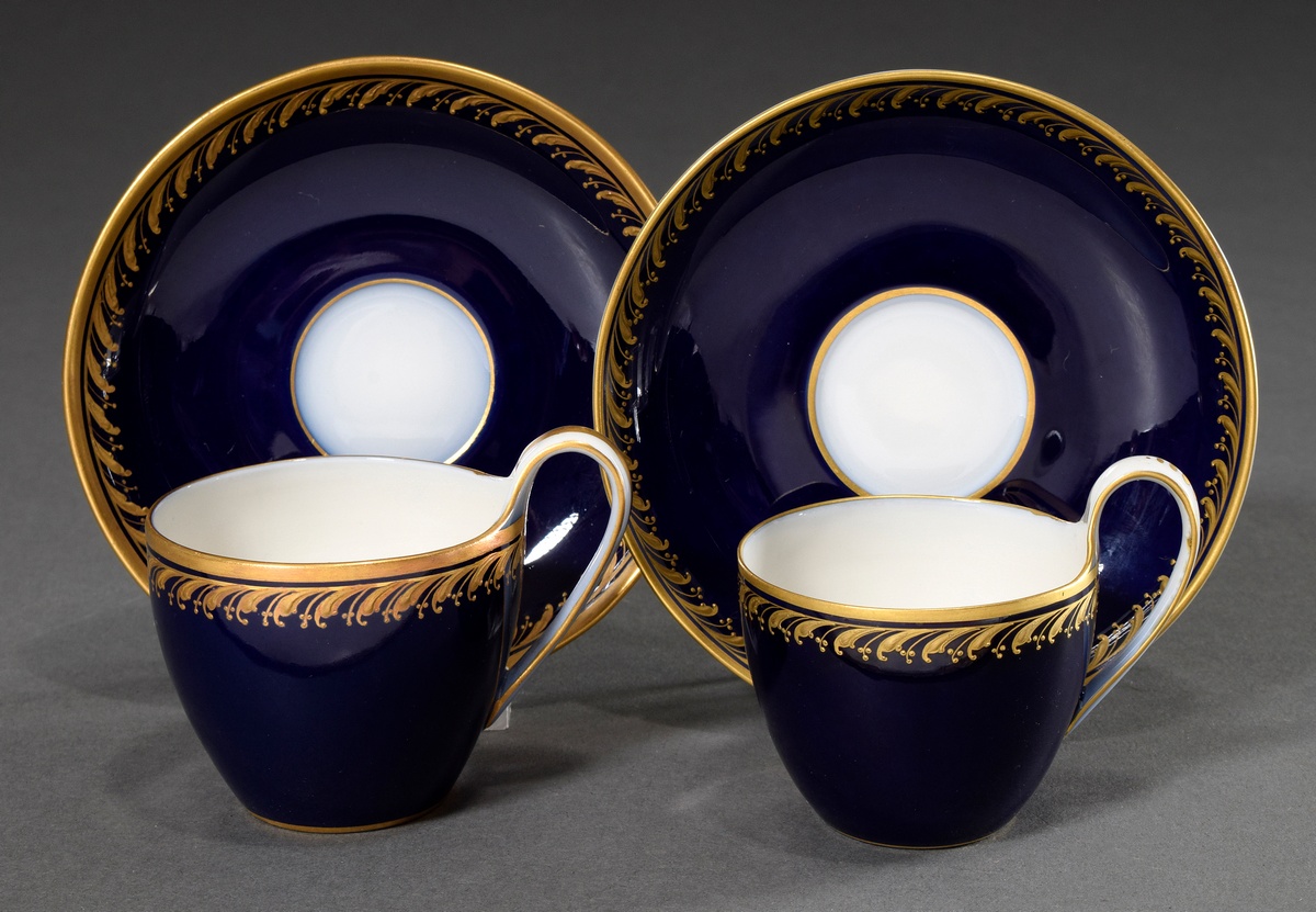 2 Various KPM moch cups/saucers in Campanian form with relief gold border on cobalt blue background