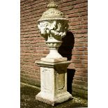 Cast or sandstone lidded vase with ram's head on a high angular pedestal after an old model, marked