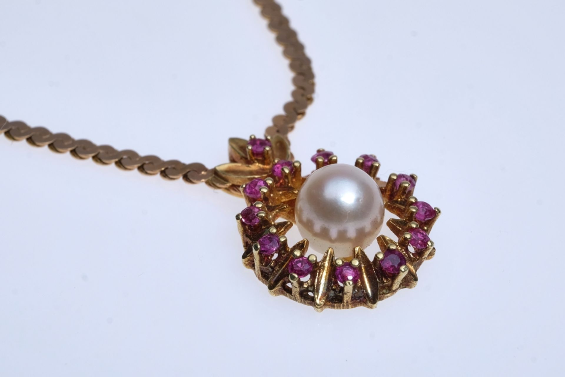 Collier with pendant, set with cultured pearl and wreath of genuine rubies, all tested, chain and s