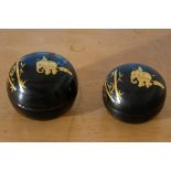 Two lacquer boxes, Burma, 1980s. Black lacquer with gold decoration. Depiction of working elephants