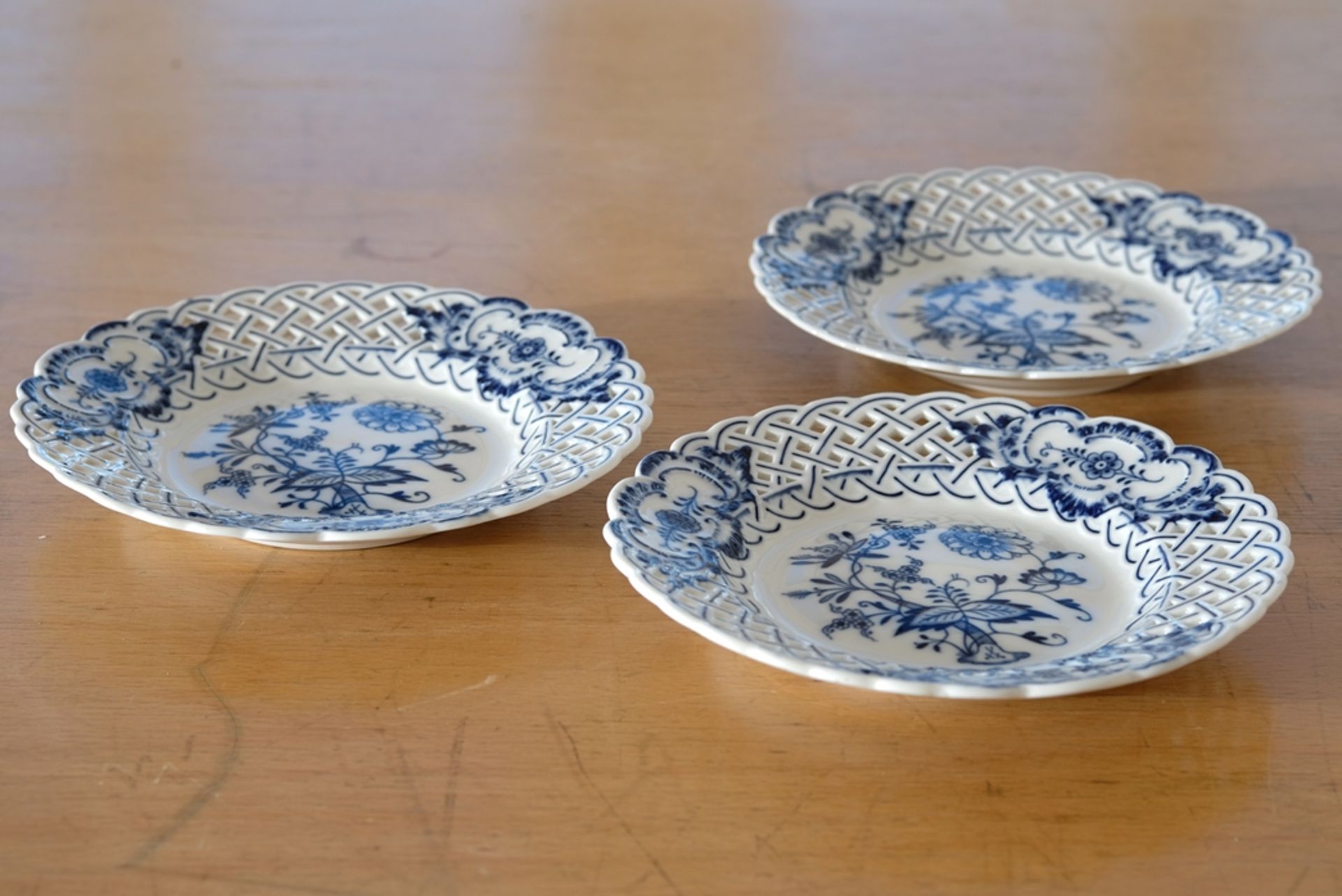 Three Meissen openwork plates, onion pattern in blue, pierced wavy rim, Meissen sword mark, mould n