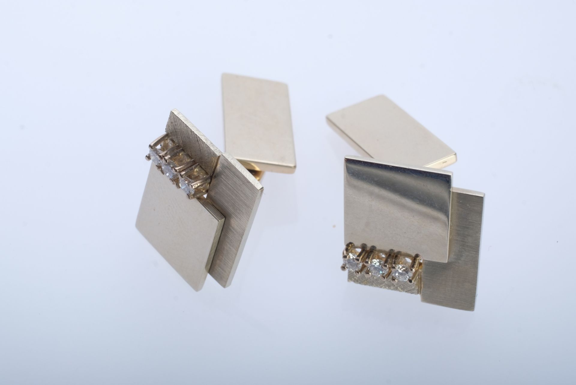 Cufflinks, geometric shapes, each set with three brilliant-cut diamonds, around 0.03ct, 750 white g