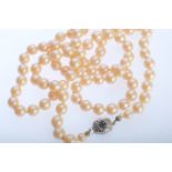 Long pearl necklace, cream-coloured pearls, clasp silver 835 and set with blue stone and diamonds, 