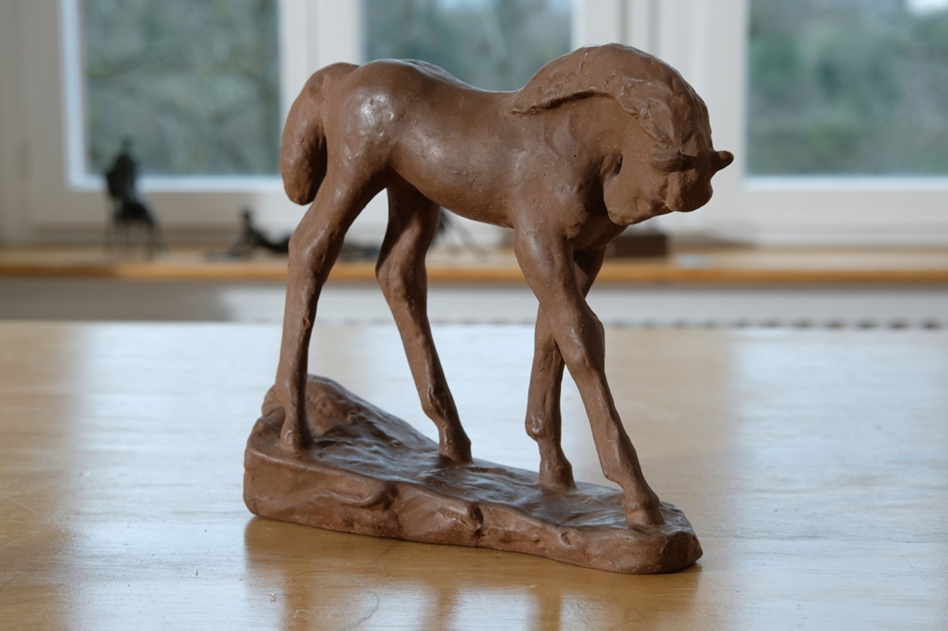 Filly figure made of brown clay, in the style of Karlsruhe majolica. 