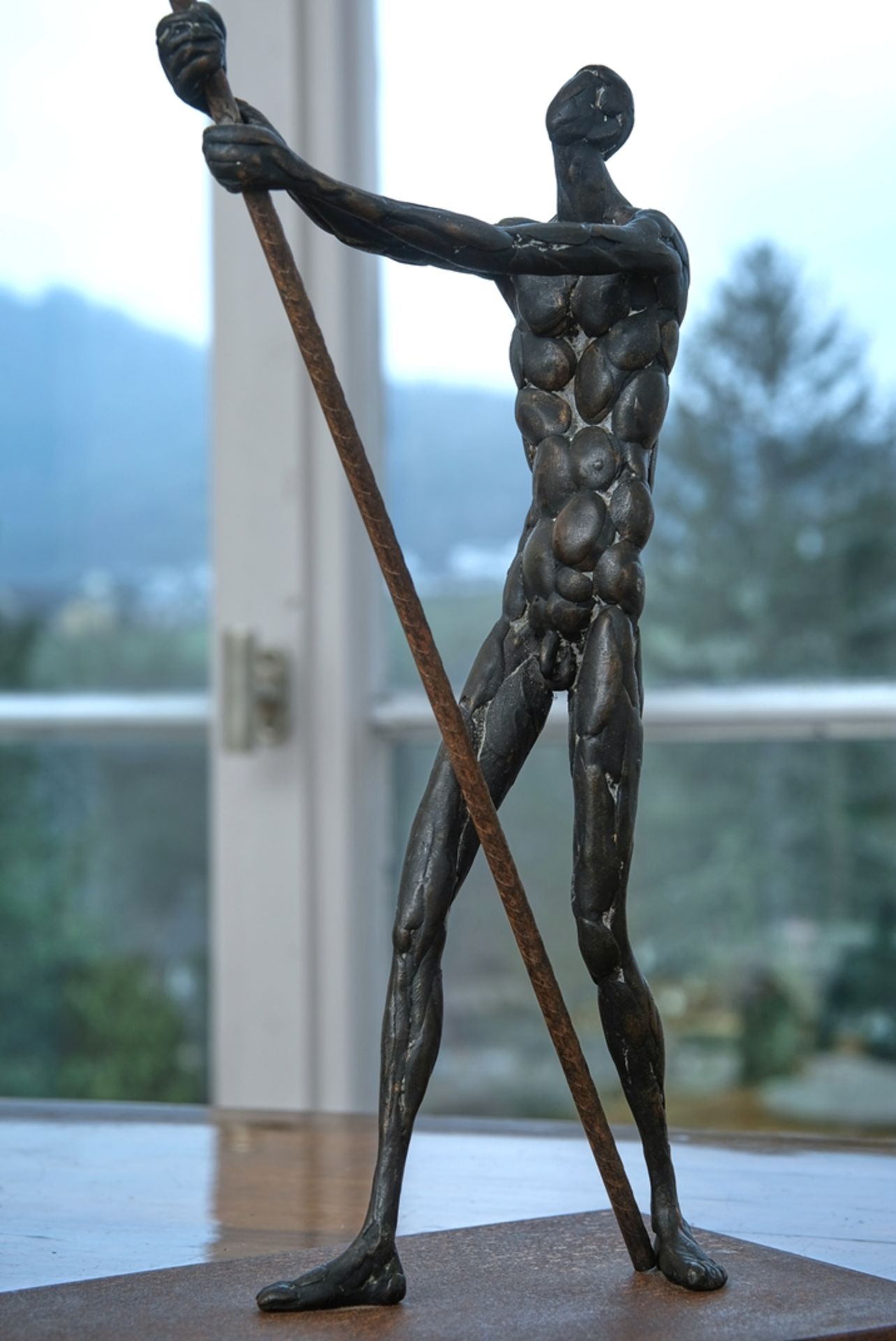 Martin, Roland (born 1927) Standing male nude with pole, on thin plinth.