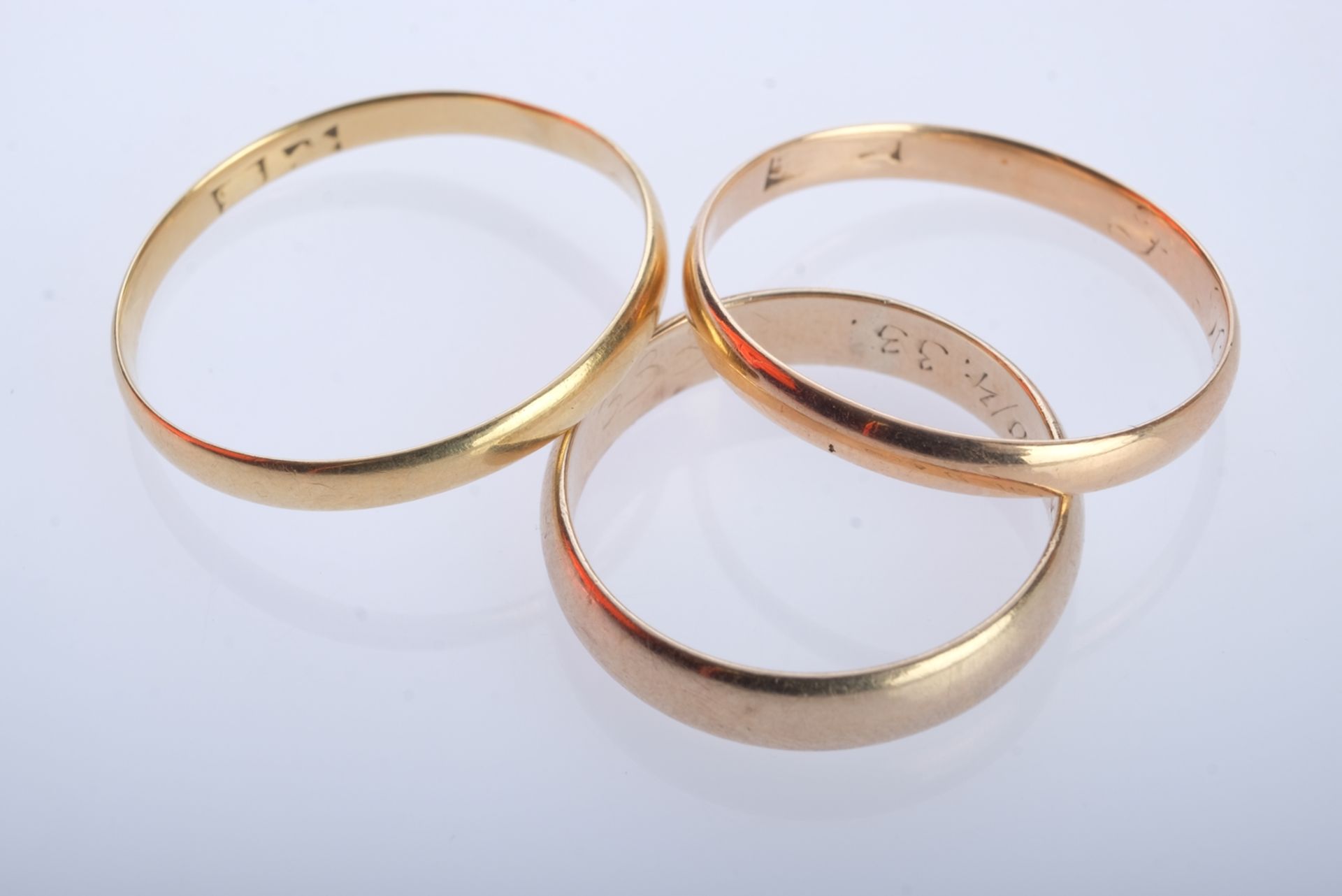 Three fine gold rings, size 62/61/55, yellow gold 333 (tested), together 4.86g